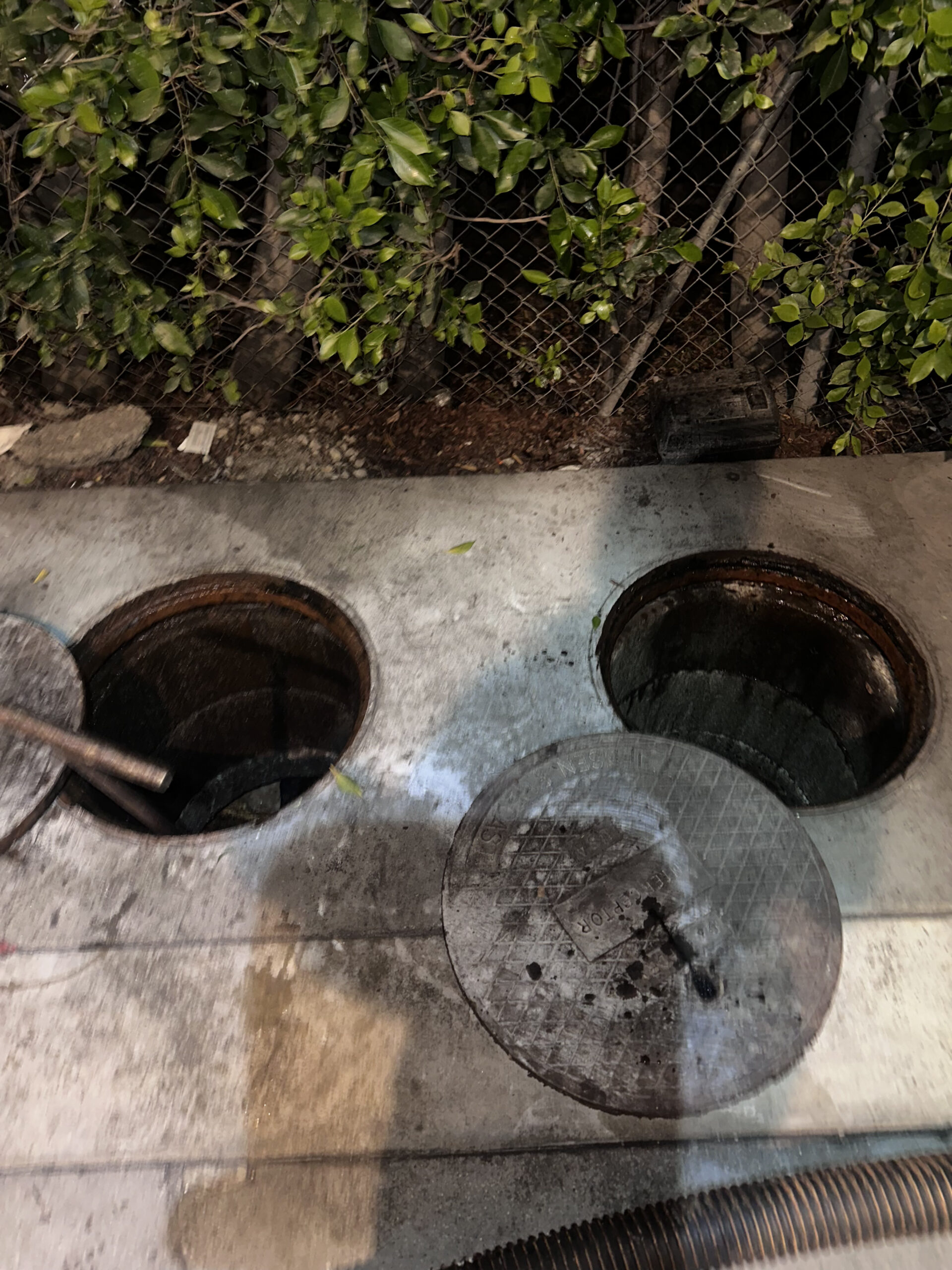 Open grease trap lid showing the interior of a commercial grease trap