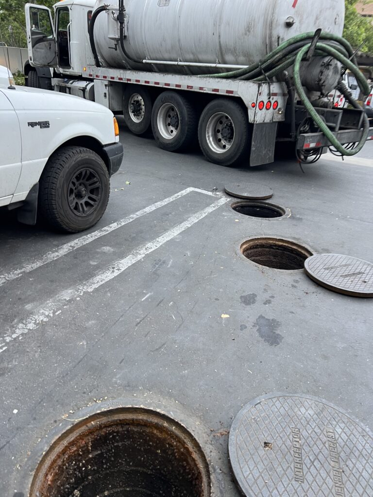 Technician providing grease interceptor service for a Los Angeles commercial kitchen