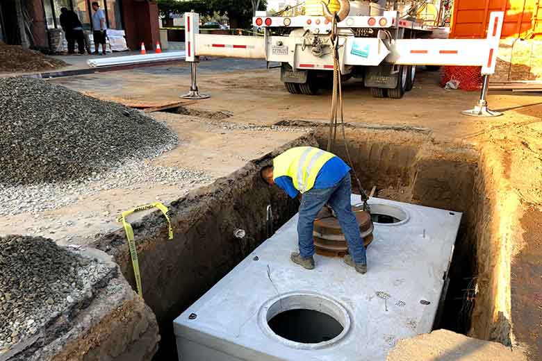 Large commercial grease trap replacement operation in progress