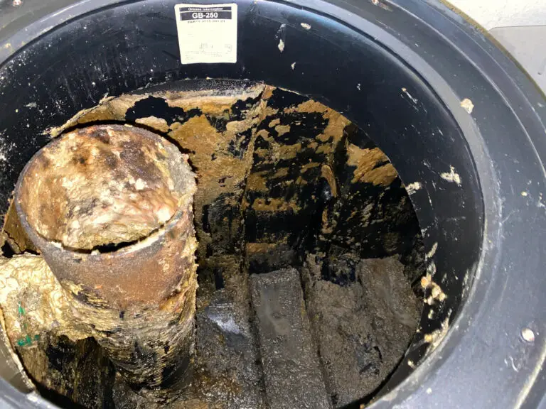 Severely damaged grease trap baffle requiring immediate professional repair